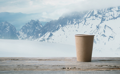 Image showing Single tea or coffee mug and landscape of mountains on background