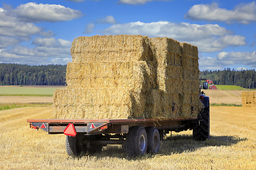 Image showing Tractor with Load of Straw Bales on Trailer