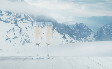 Image showing Champagne in glasses and landscape of mountains on background