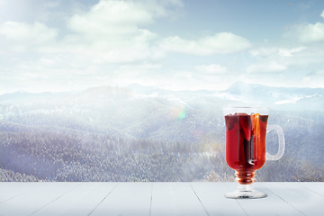 Image showing Mulled wine and landscape of mountains on background