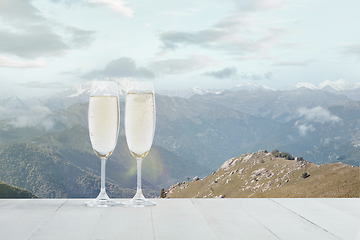 Image showing Champagne in glasses and landscape of mountains on background