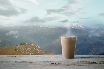 Image showing Single tea or coffee mug and landscape of mountains on background