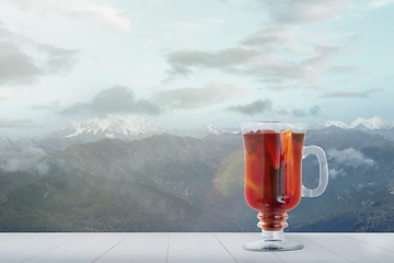 Image showing Mulled wine and landscape of mountains on background