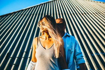 Image showing Tanned young caucasian couple, modern lovestory in film grain effect