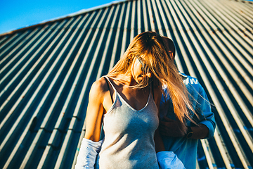 Image showing Tanned young caucasian couple, modern lovestory in film grain effect