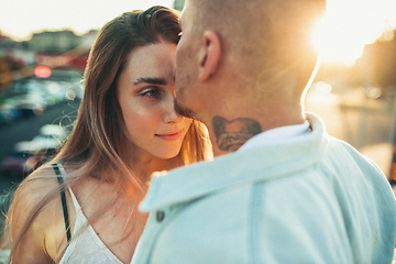 Image showing Tanned young caucasian couple, modern lovestory in film grain effect