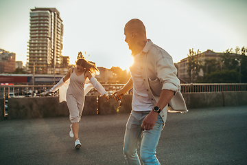 Image showing Tanned young caucasian couple, modern lovestory in film grain effect