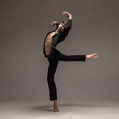 Image showing Man in casual office style clothes jumping isolated on studio background