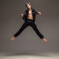 Image showing Man in casual office style clothes jumping isolated on studio background