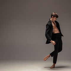 Image showing Man in casual office style clothes jumping isolated on studio background