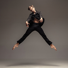 Image showing Man in casual office style clothes jumping isolated on studio background