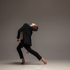 Image showing Man in casual office style clothes jumping isolated on studio background