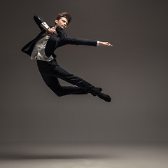 Image showing Man in casual office style clothes jumping isolated on studio background