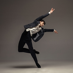 Image showing Man in casual office style clothes jumping isolated on studio background