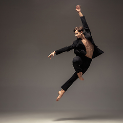 Image showing Man in casual office style clothes jumping isolated on studio background