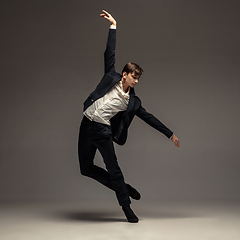 Image showing Man in casual office style clothes jumping isolated on studio background