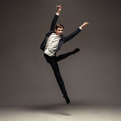 Image showing Man in casual office style clothes jumping isolated on studio background