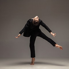 Image showing Man in casual office style clothes jumping isolated on studio background