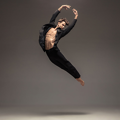 Image showing Man in casual office style clothes jumping isolated on studio background