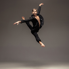 Image showing Man in casual office style clothes jumping isolated on studio background