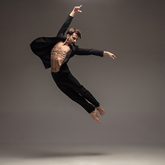 Image showing Man in casual office style clothes jumping isolated on studio background