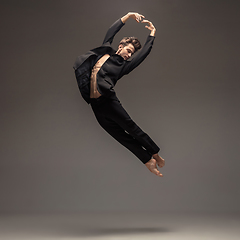 Image showing Man in casual office style clothes jumping isolated on studio background