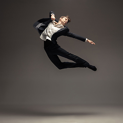 Image showing Man in casual office style clothes jumping isolated on studio background