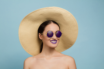 Image showing Portrait of beautiful young woman with bright make-up isolated on blue studio background