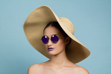 Image showing Portrait of beautiful young woman with bright make-up isolated on blue studio background