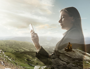 Image showing Silhouette of businesswoman with landscapes on background, double exposure.