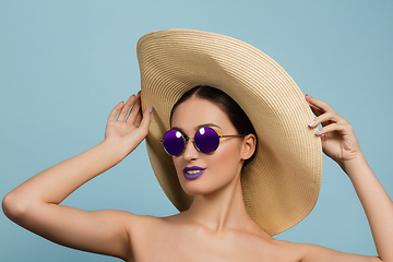 Image showing Portrait of beautiful young woman with bright make-up isolated on blue studio background