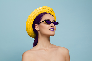 Image showing Portrait of beautiful young woman with bright make-up isolated on blue studio background