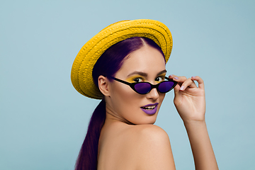 Image showing Portrait of beautiful young woman with bright make-up isolated on blue studio background