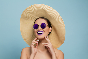 Image showing Portrait of beautiful young woman with bright make-up isolated on blue studio background