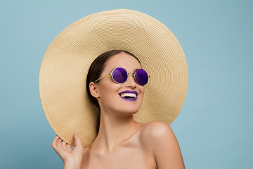 Image showing Portrait of beautiful young woman with bright make-up isolated on blue studio background