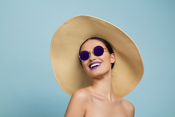 Image showing Portrait of beautiful young woman with bright make-up isolated on blue studio background