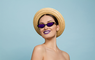 Image showing Portrait of beautiful young woman with bright make-up isolated on blue studio background