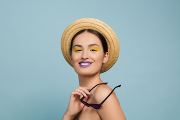 Image showing Portrait of beautiful young woman with bright make-up isolated on blue studio background