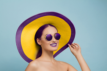 Image showing Portrait of beautiful young woman with bright make-up isolated on blue studio background