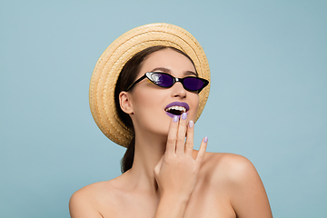 Image showing Portrait of beautiful young woman with bright make-up isolated on blue studio background