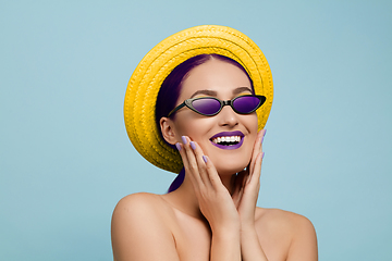 Image showing Portrait of beautiful young woman with bright make-up isolated on blue studio background