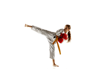 Image showing Confident junior in kimono practicing hand-to-hand combat, martial arts