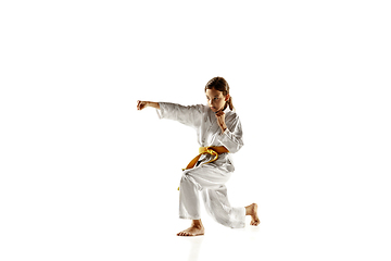 Image showing Confident junior in kimono practicing hand-to-hand combat, martial arts