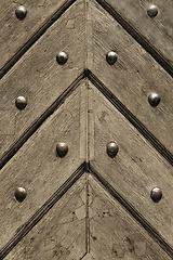 Image showing Fragment of old wooden doors with metal rivets