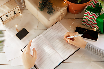 Image showing Writes wishes, dreams and goals, making plan for New Year and Christmas