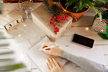 Image showing Writes wishes, dreams and goals, making plan for New Year and Christmas