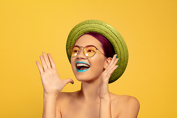 Image showing Portrait of beautiful young woman with bright make-up isolated on yellow studio background