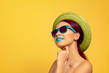 Image showing Portrait of beautiful young woman with bright make-up isolated on yellow studio background