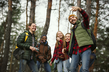 Image showing Group of friends on a camping or hiking trip in autumn day