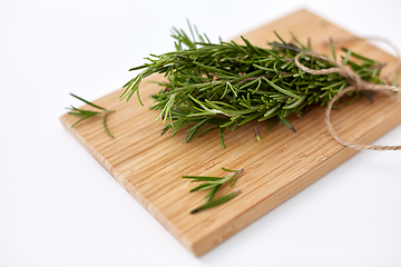 Image showing bunch of rosemary on wooden cutting board